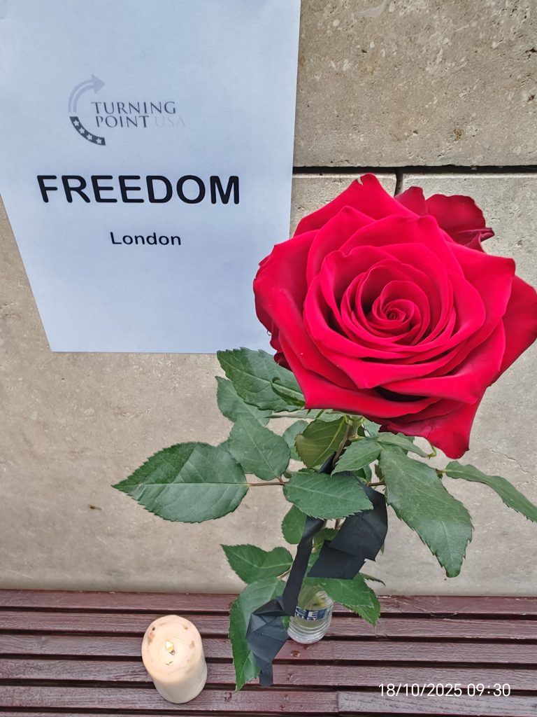 Close-up of an American flag 🇺🇸 with a lit candle 🕯️